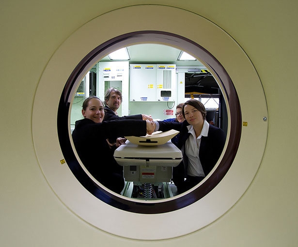 The handshake to mark the handover of the three French CT Scanners. Pictured on the left is Penny Rogers, Marshall Project Manager, and front right Elodie Winizuk, SSA Project Manager